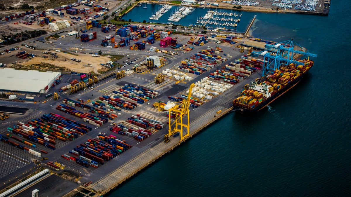 Aerial view of a container port with a loaded container ship at the berth